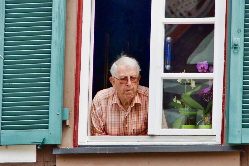 Elderly Man Looking Out Window Safety