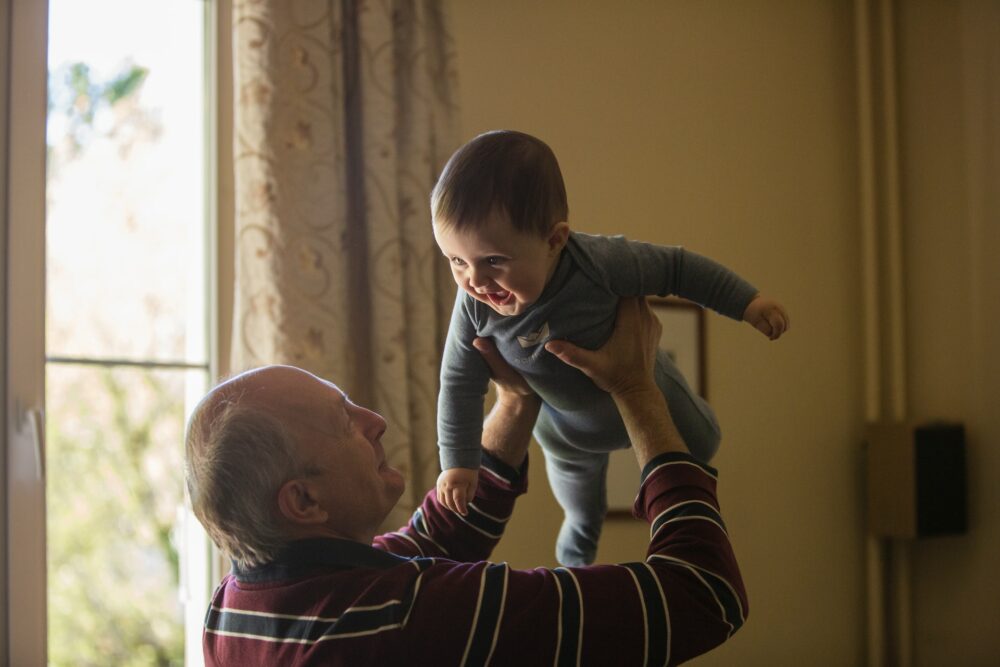 Elderly Man With Baby Holidays