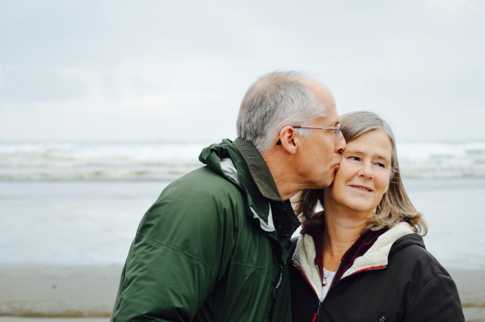 Elderly Man Kissing Elderly Woman On Cheek