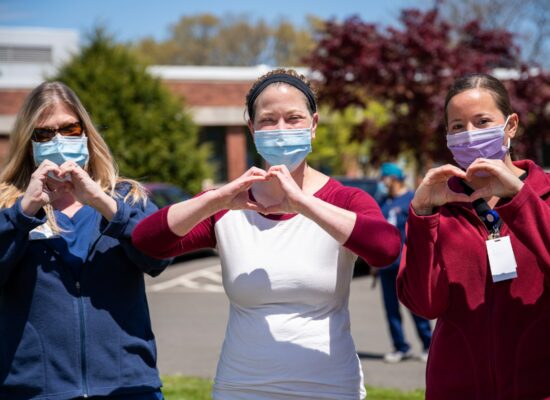 Three Nurses Signaling Hearts With Hands