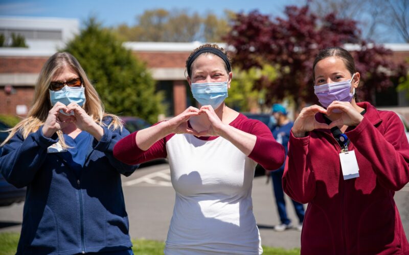Three Nurses Signaling Hearts With Hands